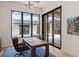 Bright office with large windows overlooking a covered outdoor living area and pool at 1624 Turnbull Crossings Dr, New Smyrna Beach, FL 32168