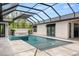 Bask in luxury with this screened-in pool featuring a spa, perfect for entertaining guests at 1624 Turnbull Crossings Dr, New Smyrna Beach, FL 32168