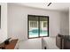 Living space with a view of a luxurious outdoor pool through sliding glass doors at 1624 Turnbull Crossings Dr, New Smyrna Beach, FL 32168