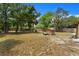 The spacious backyard features mature trees, storage shed, and a fenced perimeter at 1718 Maryland Ave, Ormond Beach, FL 32174