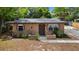 Charming single-story home featuring a cozy front porch and natural landscaping at 1718 Maryland Ave, Ormond Beach, FL 32174