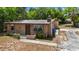 Charming single-story home with a dark front door and stucco exterior, surrounded by mature trees at 1718 Maryland Ave, Ormond Beach, FL 32174