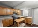 Traditional kitchen with wooden cabinets, gray countertops and stainless steel range at 1718 Maryland Ave, Ormond Beach, FL 32174