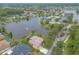 Aerial view showcasing a home with a screened in pool with a lake view at 1734 Covendale Ln, Port Orange, FL 32128
