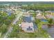 Aerial view of a home with a screened pool, lake, and well-maintained landscaping at 1734 Covendale Ln, Port Orange, FL 32128