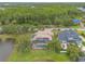 Aerial view of property showcasing the screen enclosed pool, lake, landscaping, and surrounding neighborhood at 1734 Covendale Ln, Port Orange, FL 32128