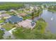 Beautiful aerial view of a single-Gathering home with screened pool, mature landscaping, and lake at 1734 Covendale Ln, Port Orange, FL 32128
