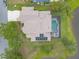 Top down aerial view of home showing solar panels and screen enclosed pool near the lake at 1734 Covendale Ln, Port Orange, FL 32128