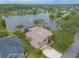 Aerial view of the home showing the private lake, screened in pool and manicured lawn at 1734 Covendale Ln, Port Orange, FL 32128
