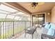 Covered balcony with seating, ceiling fan, and lake views at 1734 Covendale Ln, Port Orange, FL 32128