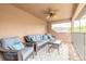 Outdoor covered balcony with seating, ceiling fan, and stylish decor at 1734 Covendale Ln, Port Orange, FL 32128