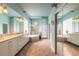The luxurious bathroom has a double vanity, a soaking tub, a tiled shower, and a large mirror at 1734 Covendale Ln, Port Orange, FL 32128