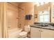 Bathroom featuring neutral walls, a shower with tub, and a single sink vanity with a marble-look countertop at 1734 Covendale Ln, Port Orange, FL 32128
