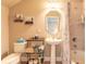 Full bathroom with a pedestal sink, bathtub/shower combo, and decorative shelving at 1734 Covendale Ln, Port Orange, FL 32128