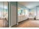The luxurious bathroom has a double vanity, a soaking tub, a tiled shower, and a walk in closet at 1734 Covendale Ln, Port Orange, FL 32128