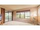 Bright bedroom featuring large windows with lake views and sliding door access to balcony at 1734 Covendale Ln, Port Orange, FL 32128