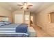 Spacious bedroom featuring carpet flooring, a ceiling fan, and an open view of the en suite bathroom at 1734 Covendale Ln, Port Orange, FL 32128