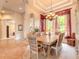 Elegant dining room featuring a large table, seating for six, decorative chandelier, and bright natural light at 1734 Covendale Ln, Port Orange, FL 32128