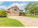 Charming home with a three car garage, nice landscaping, and a well-manicured lawn at 1734 Covendale Ln, Port Orange, FL 32128