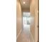 Hallway leading to a light and airy bedroom with lake views and access to the outdoor patio at 1734 Covendale Ln, Port Orange, FL 32128