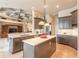 Open kitchen with a large island, stainless steel appliances, and seamless flow to living space at 1734 Covendale Ln, Port Orange, FL 32128