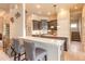 Modern kitchen featuring an island with seating, gray cabinets, and stainless appliances at 1734 Covendale Ln, Port Orange, FL 32128