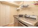 Functional laundry room with modern washer and dryer, storage shelves, and a neutral color scheme at 1734 Covendale Ln, Port Orange, FL 32128