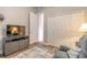 Living room with a large television, closet, and an open doorway at 1734 Covendale Ln, Port Orange, FL 32128