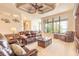 Spacious living room with leather furniture, recessed lighting, coffered ceiling, and large windows with a beautiful view at 1734 Covendale Ln, Port Orange, FL 32128