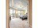 Spacious main bedroom suite with tray ceilings, lake views, and outdoor access at 1734 Covendale Ln, Port Orange, FL 32128