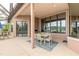 Covered patio with a dining set, grill, and view of the pool and waterfront area at 1734 Covendale Ln, Port Orange, FL 32128