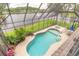 Screened pool area overlooking the lake, featuring a built-in spa and comfortable seating at 1734 Covendale Ln, Port Orange, FL 32128