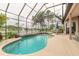 Screened-in pool and patio overlooking a scenic lake view, perfect for relaxation and entertaining at 1734 Covendale Ln, Port Orange, FL 32128