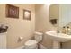 Cozy powder room featuring a pedestal sink, framed artwork, and neutral color palette at 1734 Covendale Ln, Port Orange, FL 32128