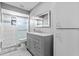 Modern bathroom features a glass-enclosed shower, gray vanity, and ample lighting at 1845 Willow Oak Dr, Edgewater, FL 32141