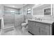 Contemporary bathroom with walk-in shower, stone tiling, and modern vanity at 1845 Willow Oak Dr, Edgewater, FL 32141