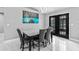 Dining area with modern light fixture, seating for six, and patio access via French doors at 1845 Willow Oak Dr, Edgewater, FL 32141