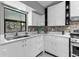 A bright kitchen featuring a modern sink, white cabinets, and stainless steel appliances at 1845 Willow Oak Dr, Edgewater, FL 32141