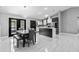 Open-concept kitchen features modern appliances, a center island with marble countertops, and access to outdoor patio at 1845 Willow Oak Dr, Edgewater, FL 32141