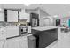 A modern kitchen with white cabinets, marble countertops, and stainless steel appliances at 1845 Willow Oak Dr, Edgewater, FL 32141
