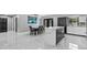 An open kitchen and dining area featuring a marble countertop island and matching dining set at 1845 Willow Oak Dr, Edgewater, FL 32141