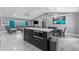 A modern kitchen featuring a marble island open to the living and dining areas at 1845 Willow Oak Dr, Edgewater, FL 32141