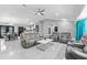 An open living room featuring contemporary furniture, tile flooring, and a ceiling fan at 1845 Willow Oak Dr, Edgewater, FL 32141