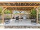 Pergola featuring an outdoor grilling area and cozy seating, perfect for entertaining at 1845 Willow Oak Dr, Edgewater, FL 32141