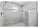 Bathroom walk-in shower featuring mosaic tiling and a contemporary showerhead fixture at 1845 Willow Oak Dr, Edgewater, FL 32141