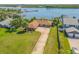 Stunning aerial view of home with lush landscaping and convenient three-car garage at 1905 S Riverside Dr, Edgewater, FL 32141