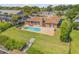 Home features a backyard oasis with a pool, patio, and lush lawn extending to the waterfront at 1905 S Riverside Dr, Edgewater, FL 32141