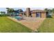 Lovely backyard features a refreshing pool with lounge chairs and a large brick patio at 1905 S Riverside Dr, Edgewater, FL 32141