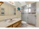 Bright bathroom with a glass shower, decorative elements, and wood vanity at 1905 S Riverside Dr, Edgewater, FL 32141