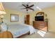 Bright bedroom features a ceiling fan, closet, and water view window at 1905 S Riverside Dr, Edgewater, FL 32141